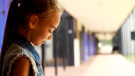 Schoolgirl-using-mobile-phone-in-locker-room-4k