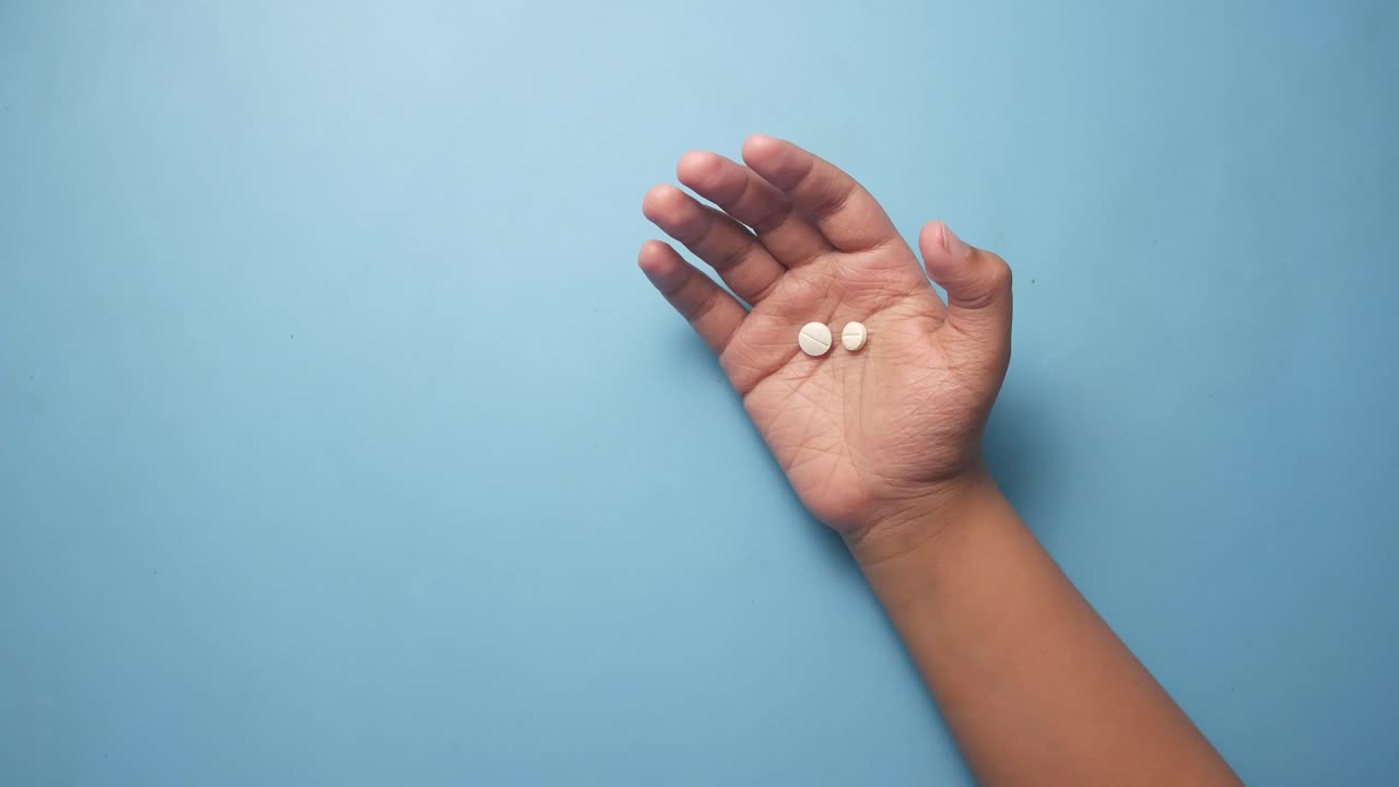 Two White Pills in Hand