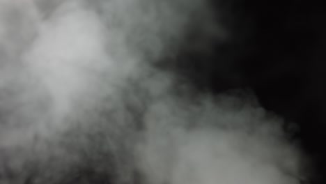 atmospheric smoke vfx overlay element. haze background. smoke in slow motion on black background. white smoke slowly floating through space against black background. mist effect. fog effect