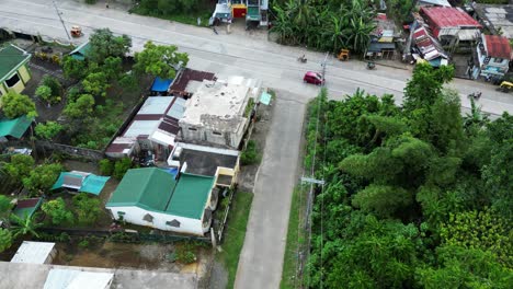 aerial birdseye view dolly over mopeds and tuk tuk driving down southeast asia street