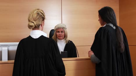 lawyers standing and listening the judge