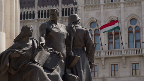 istván tisza monument in front of the hungarian parliament building facade