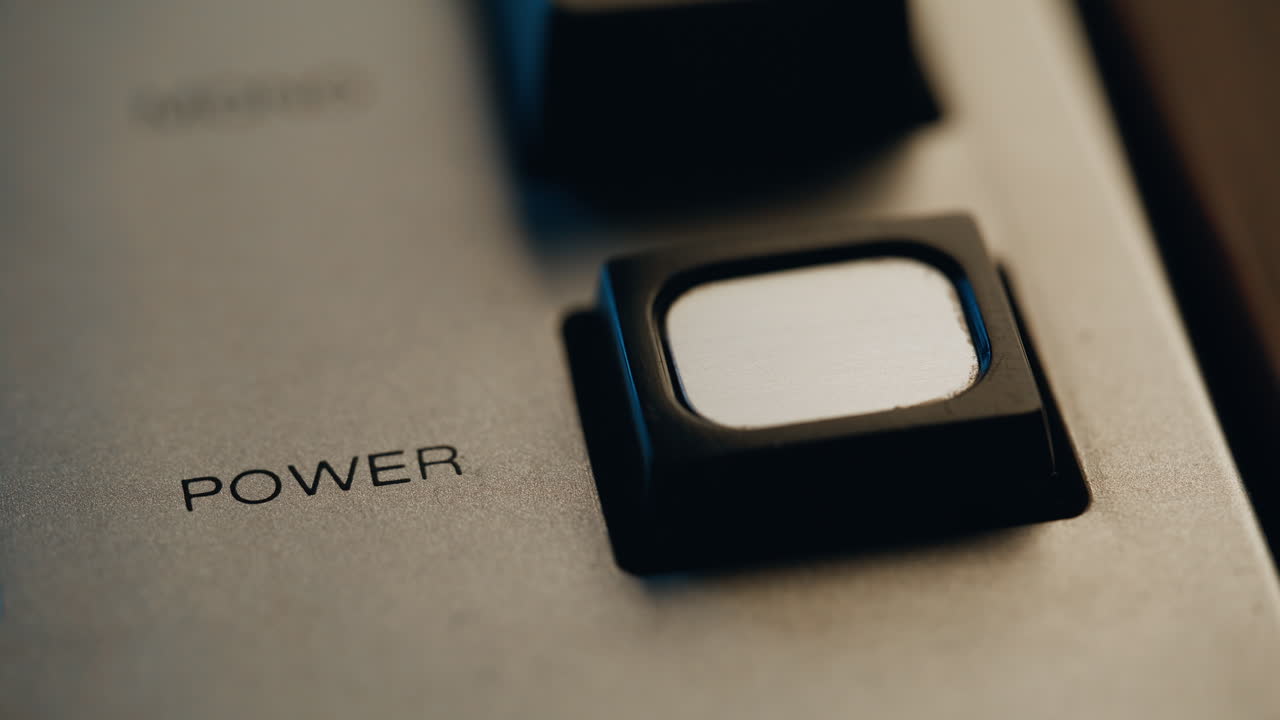 Finger turning off power button on retro device closeup. Man pushing knob