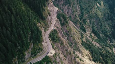 landing drone shot of a mountain road next to a cliff