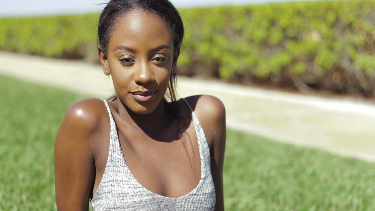 Cheerful woman on green lawn
