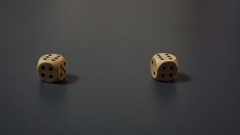 static closeup: fast rolling wooden dice ends on double six