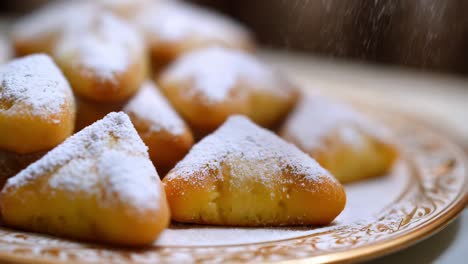 triangle shaped cookies sprinkled with powdered sugar