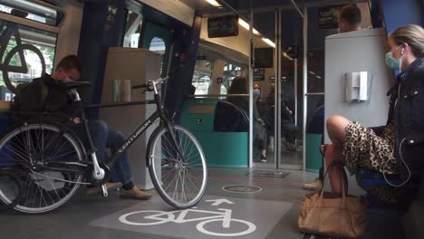 woman in medical mask getting on the train