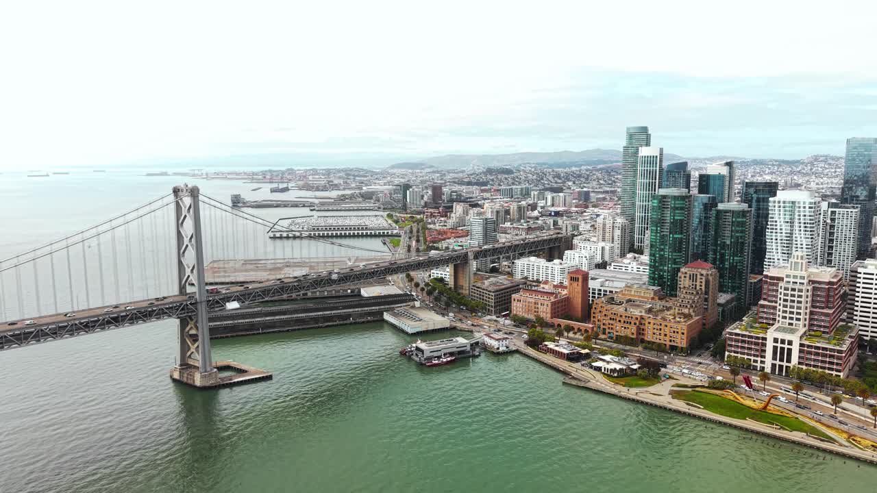 Drone Shot of San Francisco USA, Oakland Bay Bridge Traffic and Downtown Skyscrapers and Towers
