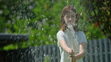 child playing with a garden hose