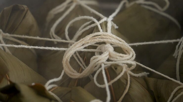 Cooking zongzi food - preparing and steaming Chinese rice dumpling.