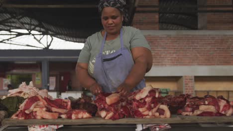 african woman looking at the meat