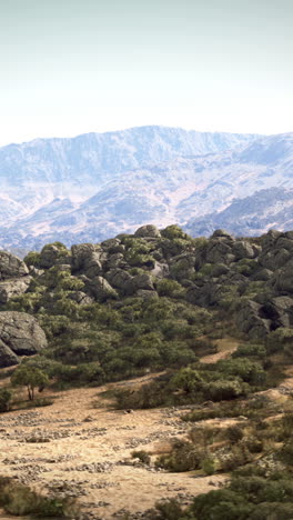 a scenic mountain landscape with a view of a distant mountain range.