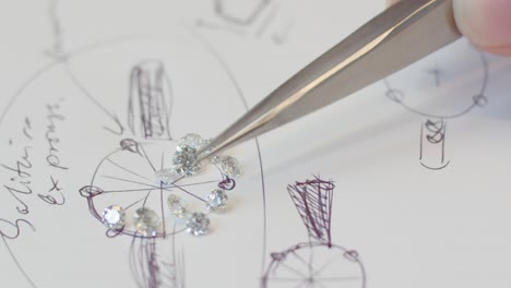 Real-diamonds-getting-sorted-on-a-sketch-of-a-diamond-wedding-ring