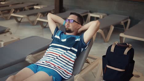 man relaxing by the pool