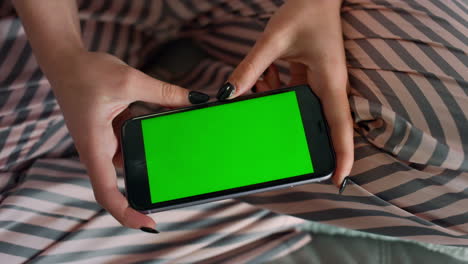 Teenager-watching-green-smartphone-in-hands-closeup.-Girl-enjoy-online-blogs