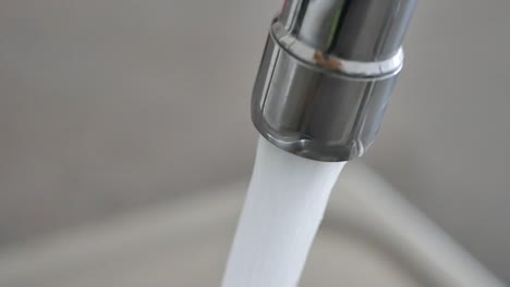 water pouring from a faucet tap slow motion