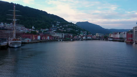 drone shot flying in towards bryggen at dawn on a beautiful quiet summer morning