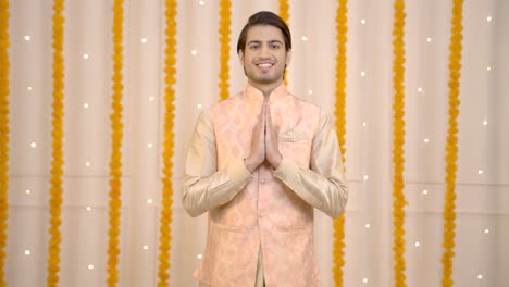 indian man welcoming guests on diwali