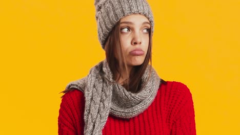 woman in winter clothes looking disappointed