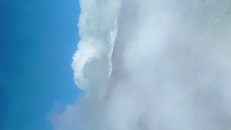 Ever-Green-Forest-Fly-through-Clouds-revealing-Shot-of-Beautiful-Mountain-Landscape-with-Dense-Forest-and-Blue-Sky,-Doi-Suthep-Doi-Pui-National-Park-Chiang-Mai,-Vertical-4k-Social-Media,-9:16-Video