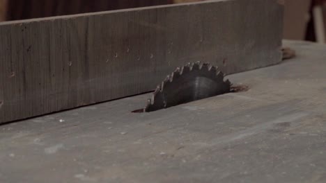 A moving shot of a table saw in a carpentry workshop