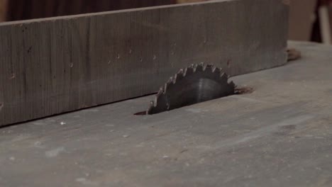 a moving shot of a table saw in a carpentry workshop