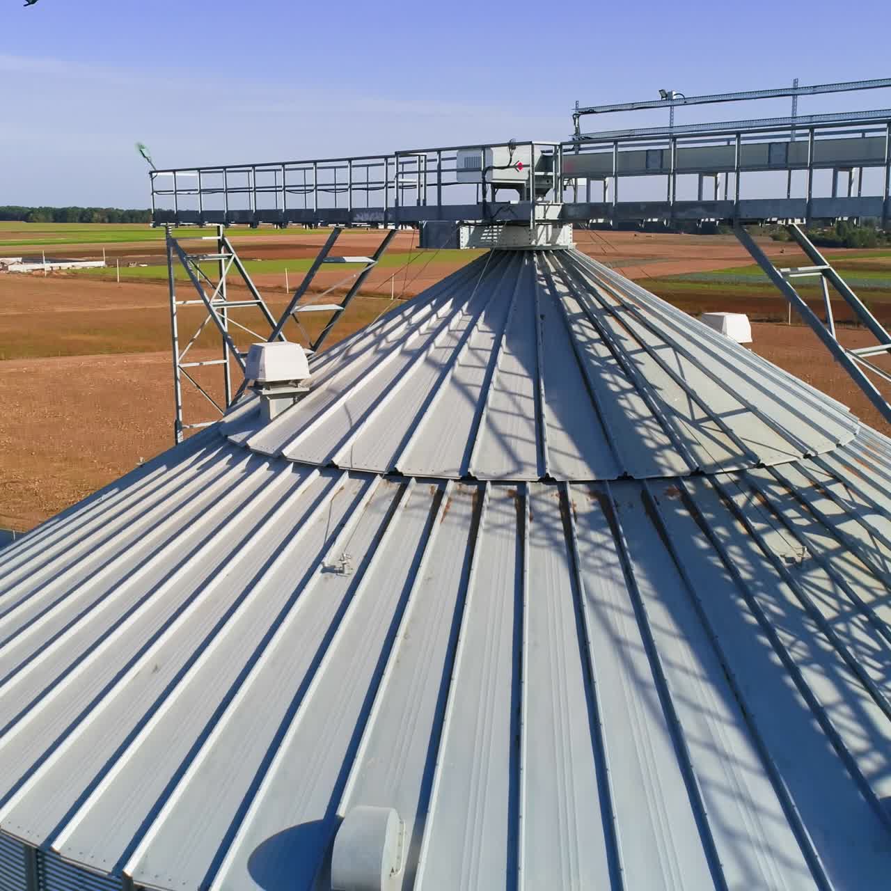 Aerial view. Metal grain elevator in agricultural zone. Grain warehouse