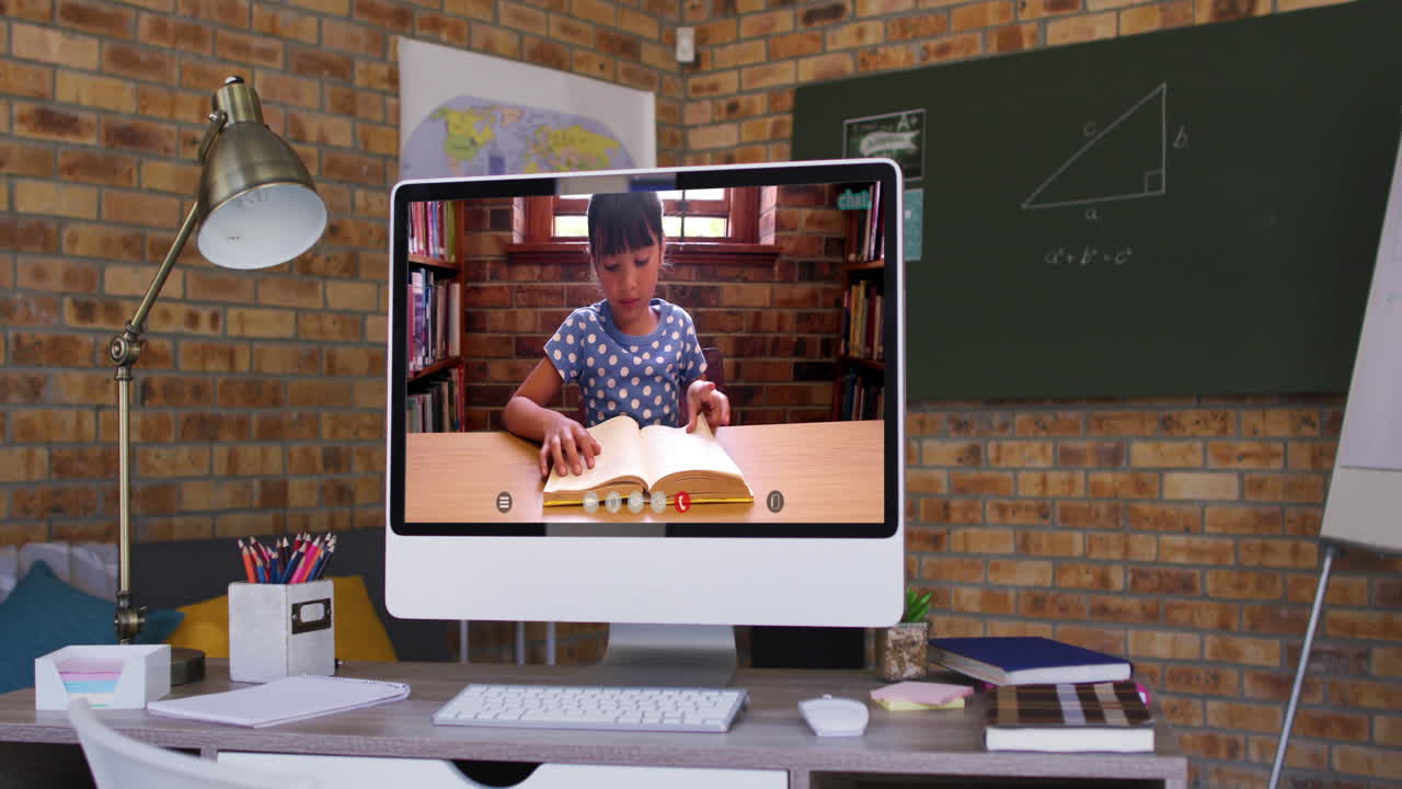 Caucasian schoolgirl learning on computer screen during video call
