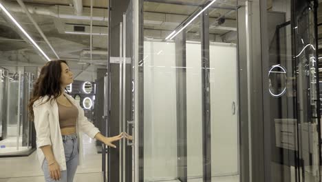 woman browsing shower enclosures and bathroom fixtures