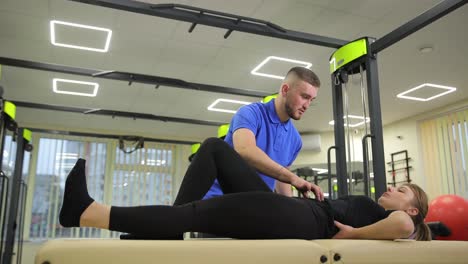 physical therapist assisting patient with hip exercises