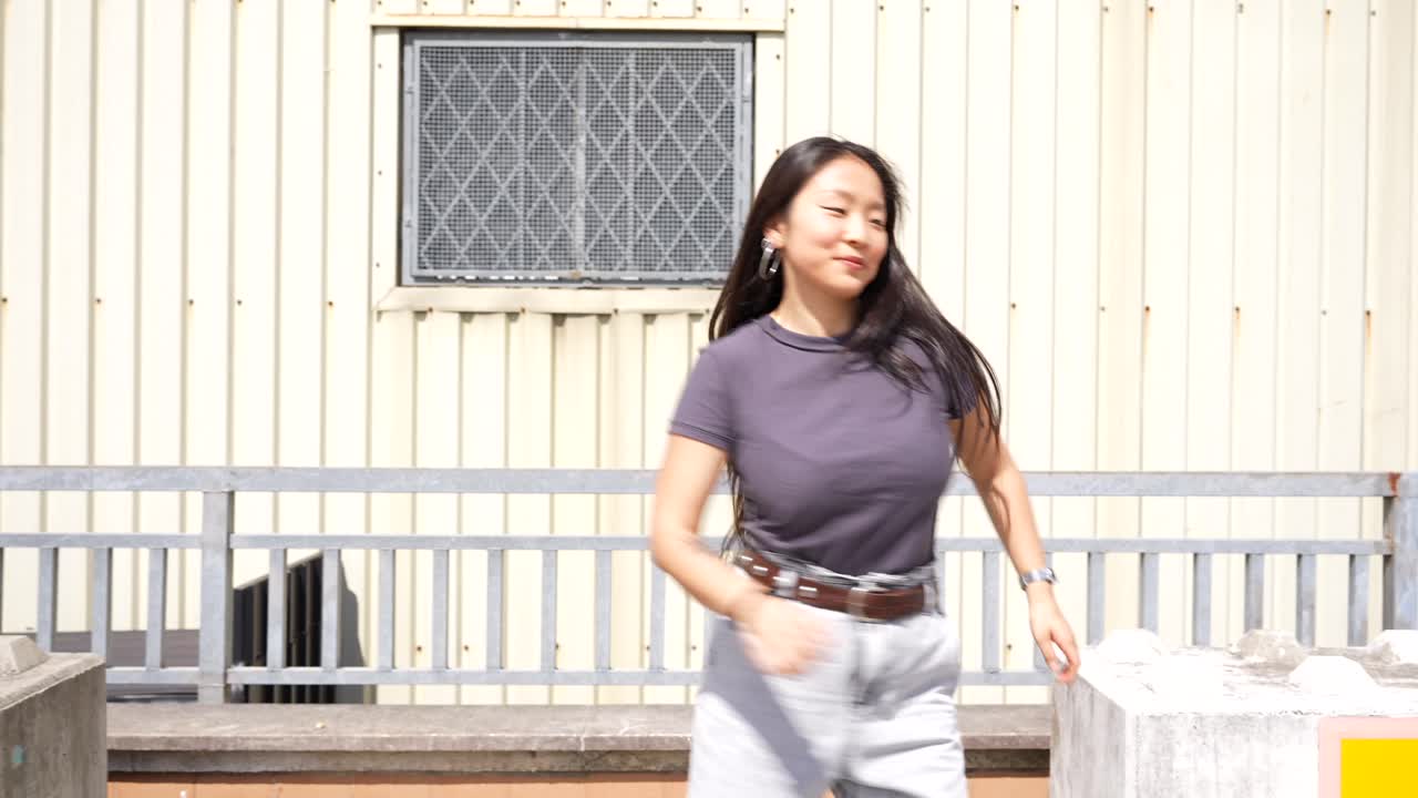 Asian woman dancing outdoors