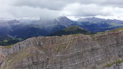 Trucking-aerial-shot-along-Seceda-Ridgeline,-stunning-Dolomites,-Italy