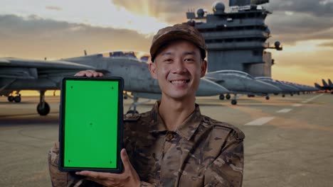 Military Personnel Presenting Green Screen Tablet on Aircraft Carrier