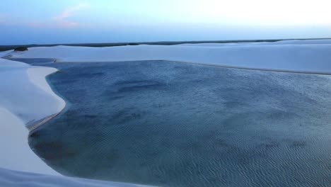 evening on beautiful lagoon and sand dune view.dunes and lagoons in lencois maranhenses national park, maranhao state.wave dunes and rainwater lagoons sunset landscape