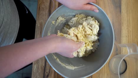 woman mixing ingredients of pasta in a bowl