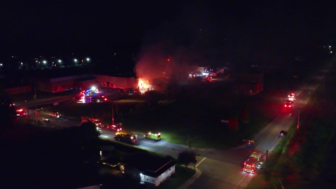 Large scale emergency response due to environmental fire hazard at night on Taschereau Blvd, aerial orbit