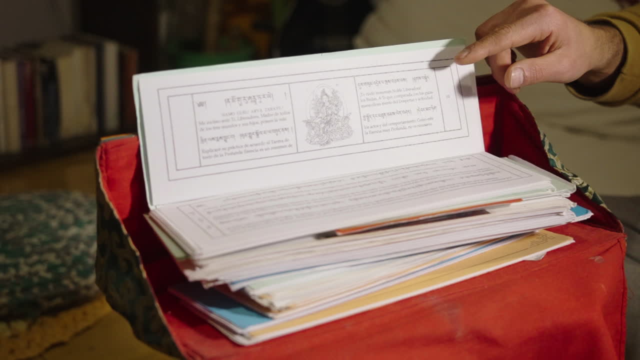 Hand Turning Pages of an Ancient Spiritual Book