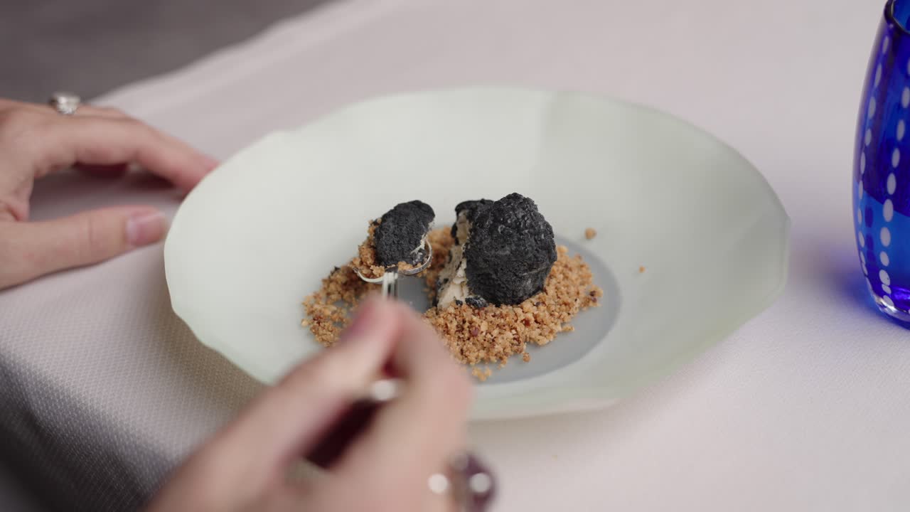 Delicate truffles enjoyed with spoon, captured in a refined restaurant close-up scene