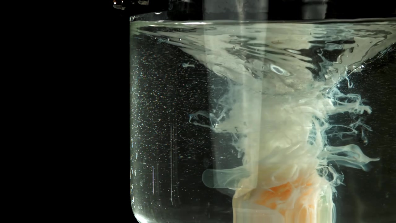 Primo piano di un uovo in camicia in acqua vorticosa in un contenitore di vetro