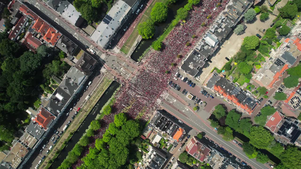 Free Palestine protest Drone aerial shows massive group of people on highway in the Hague, top down view