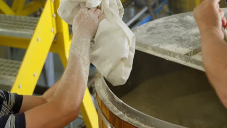 male workers preparing gin in distillery 4k