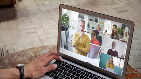 man having a video conference with multiple people