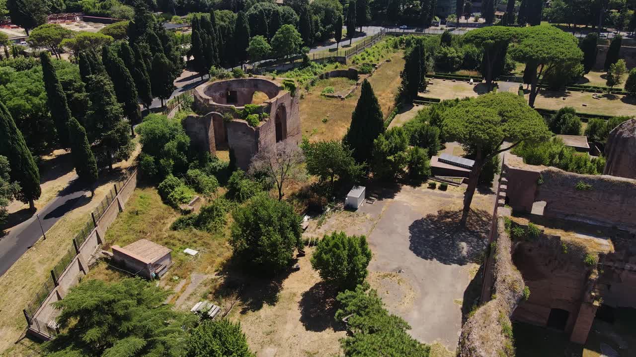 Crumbling Roman ruins and cypress trees in Rome’s ancient thermal complex, Italy