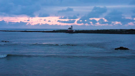 Peaceful-and-tranquil-beautiful-landscape-footage-of-drone-flying-over-the-Coquille-river-backwards,-away-from-the-Bandon-lighthouse