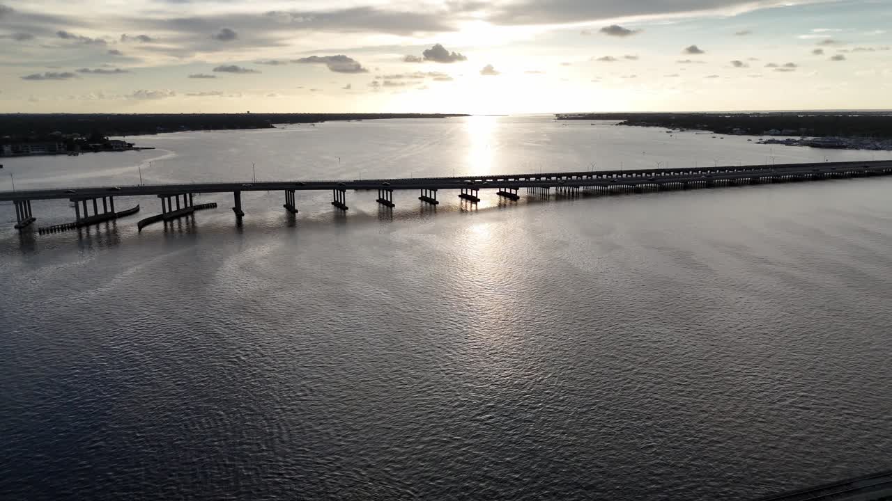 aerial falling back from Palmetto Bradenton Green Bridge over the Manatee River during sunset in Florida