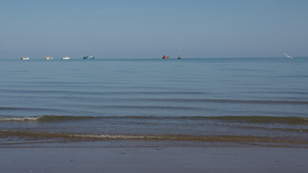 Wide shot looking straight out to sea from new quay beach at waterline
