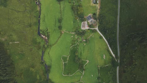 Stunning-Landscape-View-Above-The-Green-Lamb-Farmland-In-The-Valley-Of-Wicklow-Mountains-In-Ireland-On-A-Misty-Morning---aerial-drone