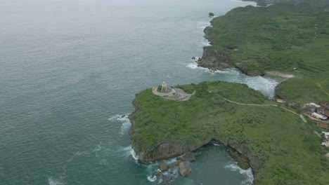 aerial view of fish monument on the cliff of beach, krakal beach, indonesia