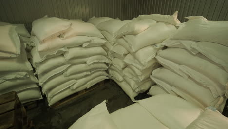 stacked bags of grain in a warehouse